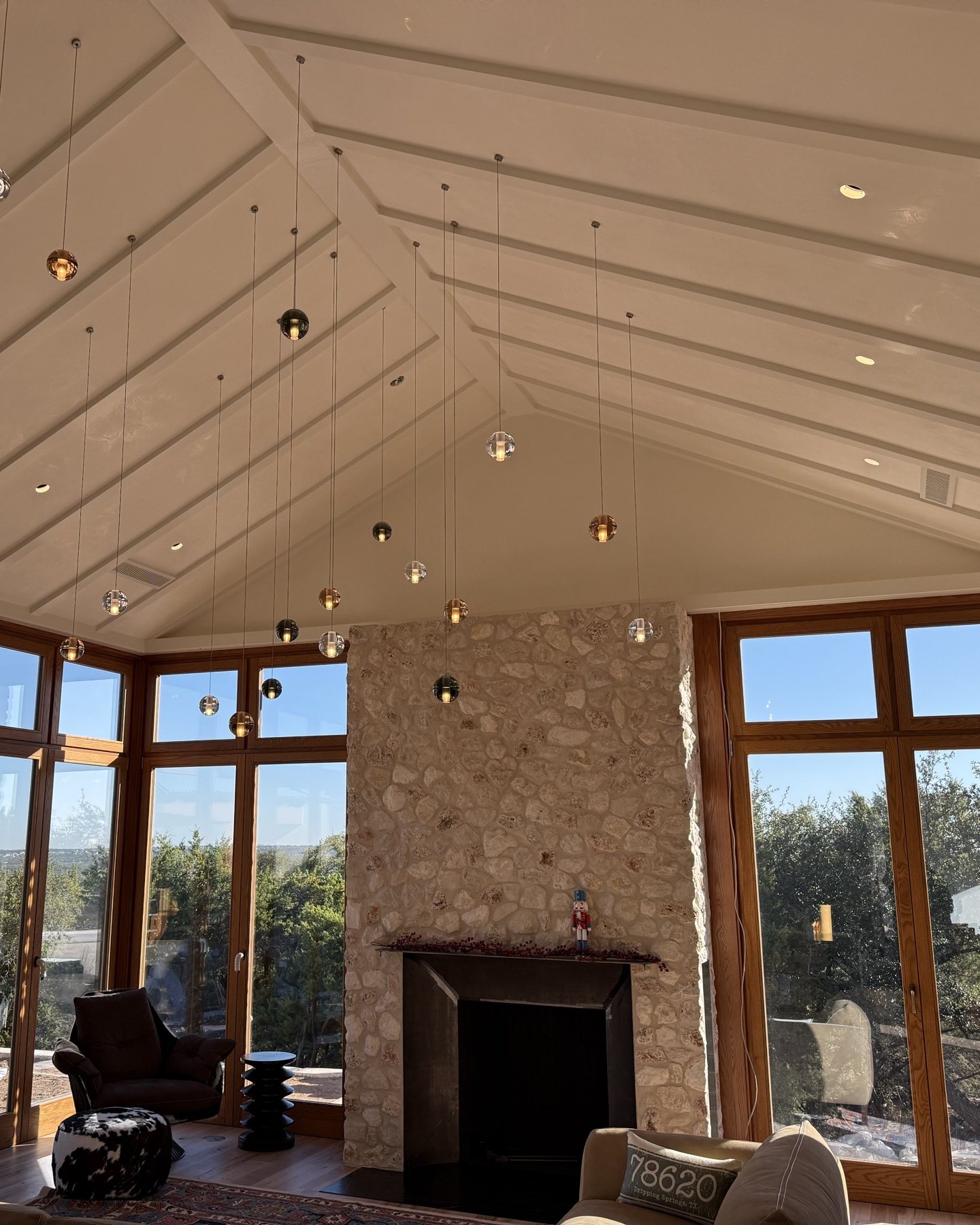 Cascading pendant lighting in a vaulted great room of a custom home
